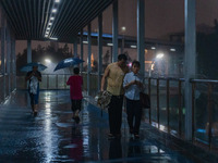 Citizens are walking through the rainstorm in central Chongqing, China, on July 13, 2024. (