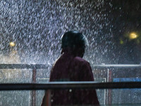 Citizens are walking through the rainstorm in central Chongqing, China, on July 13, 2024. (