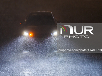 Vehicles are driving in the rainstorm in central Chongqing, China, on July 13, 2024. (