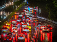 Vehicles are driving slowly in the rainstorm in central Chongqing, China, on July 13, 2024. (