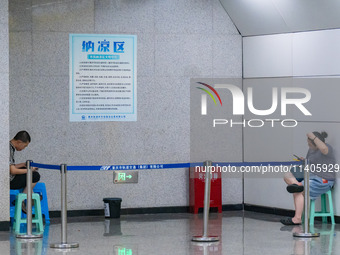 Citizens are cooling off at the platform of Line 4 of the rail transit train in Chongqing, China, on July 13, 2024. (