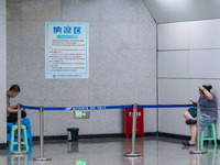 Citizens are cooling off at the platform of Line 4 of the rail transit train in Chongqing, China, on July 13, 2024. (