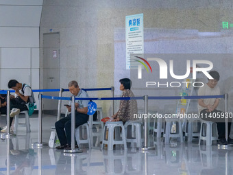 Citizens are cooling off at the platform of Line 4 of the rail transit train in Chongqing, China, on July 13, 2024. (