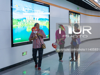 Citizens are cooling off at the platform of Line 4 of the rail transit train in Chongqing, China, on July 13, 2024. (