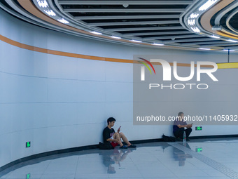 Citizens are cooling off at the platform of Line 4 of the rail transit train in Chongqing, China, on July 13, 2024. (