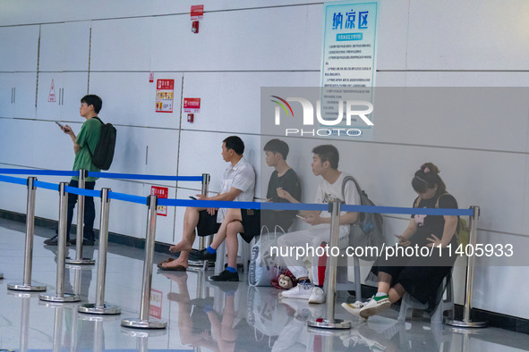 Citizens are cooling off at the platform of Line 4 of the rail transit train in Chongqing, China, on July 13, 2024. 