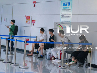 Citizens are cooling off at the platform of Line 4 of the rail transit train in Chongqing, China, on July 13, 2024. (