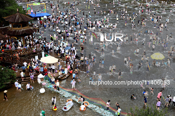 Tourists are enjoying cooling off in the water in Pingnan county, in Fujian, China, on July 13, 2024. 