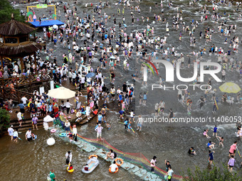 Tourists are enjoying cooling off in the water in Pingnan county, in Fujian, China, on July 13, 2024. (