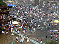 Tourists are enjoying cooling off in the water in Pingnan county, in Fujian, China, on July 13, 2024. (