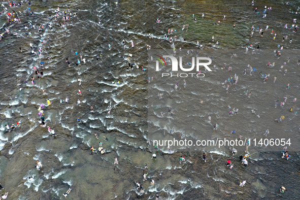 Tourists are enjoying cooling off in the water in Pingnan county, in Fujian, China, on July 13, 2024. 