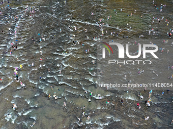 Tourists are enjoying cooling off in the water in Pingnan county, in Fujian, China, on July 13, 2024. (