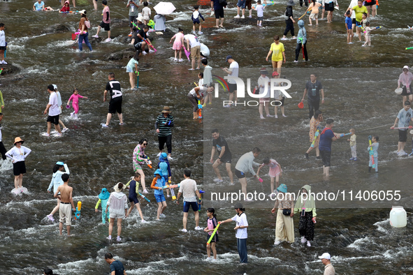 Tourists are enjoying cooling off in the water in Pingnan county, in Fujian, China, on July 13, 2024. 