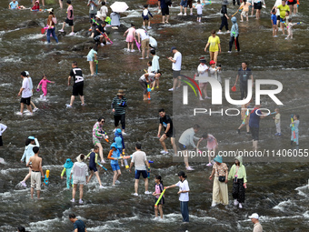 Tourists are enjoying cooling off in the water in Pingnan county, in Fujian, China, on July 13, 2024. (