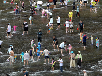 Tourists are enjoying cooling off in the water in Pingnan county, in Fujian, China, on July 13, 2024. (