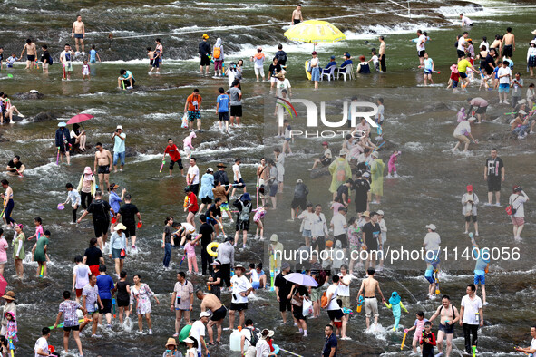 Tourists are enjoying cooling off in the water in Pingnan county, in Fujian, China, on July 13, 2024. 