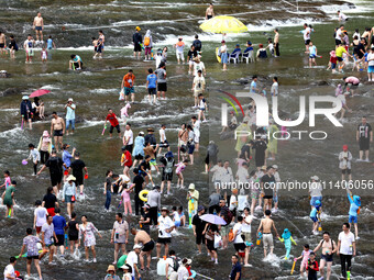 Tourists are enjoying cooling off in the water in Pingnan county, in Fujian, China, on July 13, 2024. (