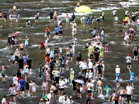 Tourists are enjoying cooling off in the water in Pingnan county, in Fujian, China, on July 13, 2024. (