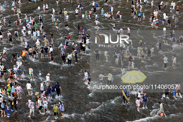 Tourists are enjoying cooling off in the water in Pingnan county, in Fujian, China, on July 13, 2024. 