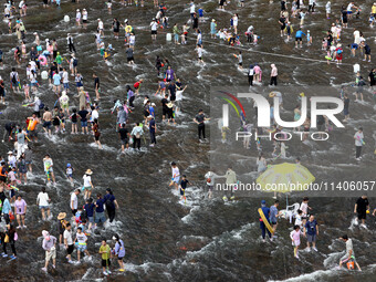 Tourists are enjoying cooling off in the water in Pingnan county, in Fujian, China, on July 13, 2024. (