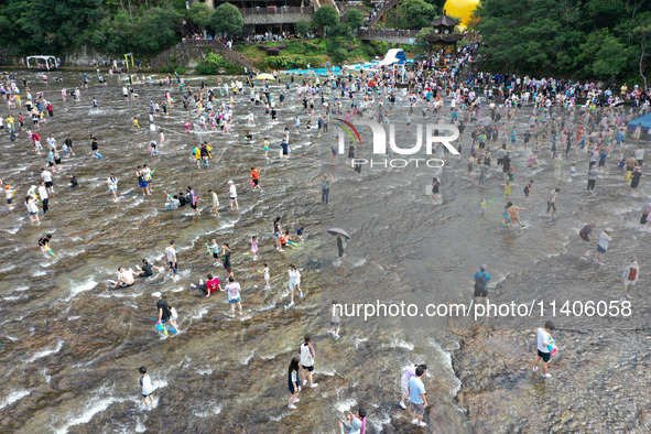 Tourists are enjoying cooling off in the water in Pingnan county, in Fujian, China, on July 13, 2024. 