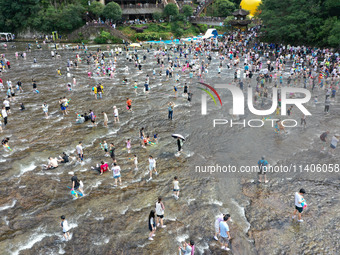 Tourists are enjoying cooling off in the water in Pingnan county, in Fujian, China, on July 13, 2024. (