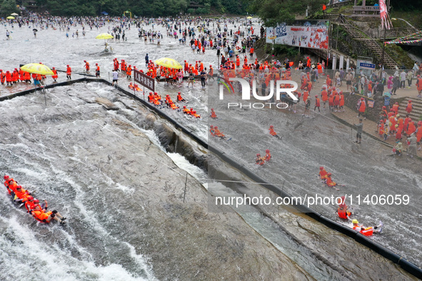 Tourists are enjoying cooling off in the water in Pingnan county, in Fujian, China, on July 13, 2024. 