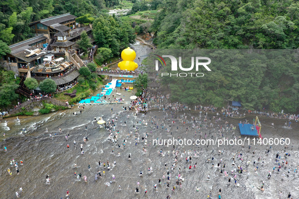 Tourists are enjoying cooling off in the water in Pingnan county, in Fujian, China, on July 13, 2024. 