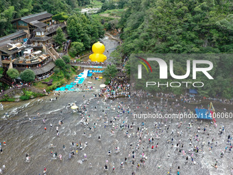 Tourists are enjoying cooling off in the water in Pingnan county, in Fujian, China, on July 13, 2024. (