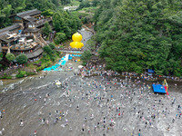 Tourists are enjoying cooling off in the water in Pingnan county, in Fujian, China, on July 13, 2024. (