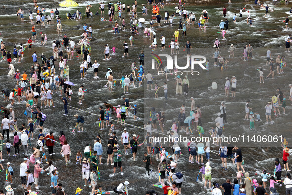 Tourists are enjoying cooling off in the water in Pingnan county, in Fujian, China, on July 13, 2024. 