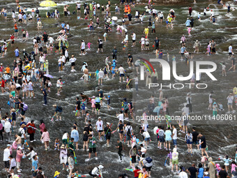 Tourists are enjoying cooling off in the water in Pingnan county, in Fujian, China, on July 13, 2024. (