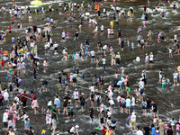 Tourists are enjoying cooling off in the water in Pingnan county, in Fujian, China, on July 13, 2024. (