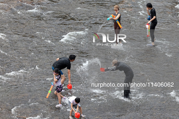 Tourists are enjoying cooling off in the water in Pingnan county, in Fujian, China, on July 13, 2024. 