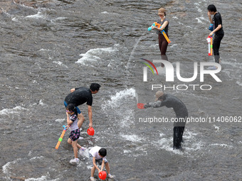 Tourists are enjoying cooling off in the water in Pingnan county, in Fujian, China, on July 13, 2024. (