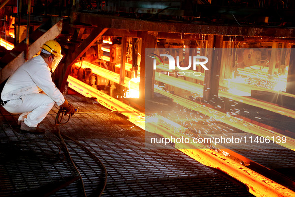 A worker is working at a steel casting workshop of a steel company in Lianyungang, China, on July 13, 2024. 