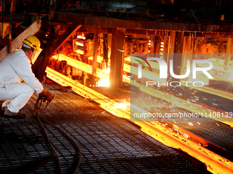 A worker is working at a steel casting workshop of a steel company in Lianyungang, China, on July 13, 2024. (