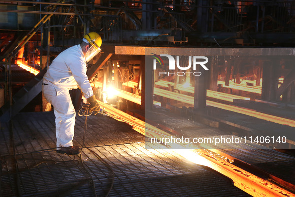 A worker is working at a steel casting workshop of a steel company in Lianyungang, China, on July 13, 2024. 