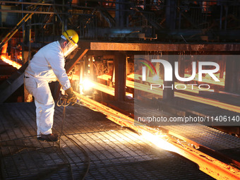 A worker is working at a steel casting workshop of a steel company in Lianyungang, China, on July 13, 2024. (