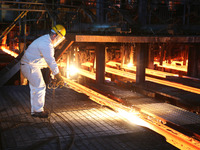 A worker is working at a steel casting workshop of a steel company in Lianyungang, China, on July 13, 2024. (