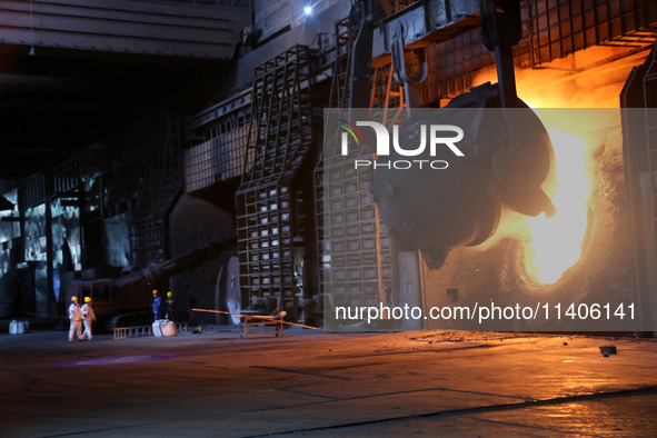 A worker is working at a steel casting workshop of a steel company in Lianyungang, China, on July 13, 2024. 