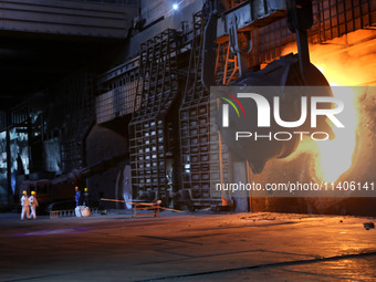 A worker is working at a steel casting workshop of a steel company in Lianyungang, China, on July 13, 2024. (