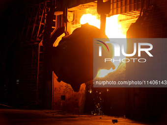 A worker is working at a steel casting workshop of a steel company in Lianyungang, China, on July 13, 2024. (