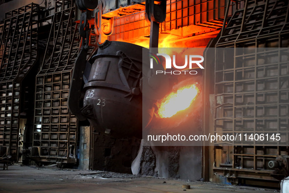 A worker is working at a steel casting workshop of a steel company in Lianyungang, China, on July 13, 2024. 