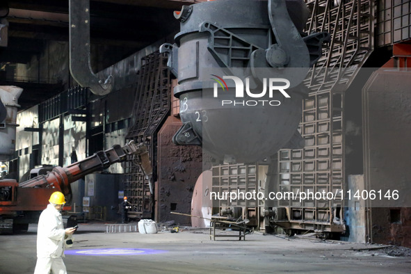 A worker is working at a steel casting workshop of a steel company in Lianyungang, China, on July 13, 2024. 