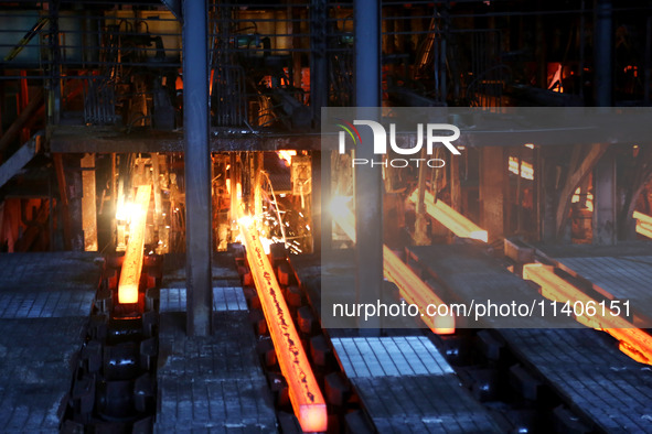 A worker is working at a steel casting workshop of a steel company in Lianyungang, China, on July 13, 2024. 