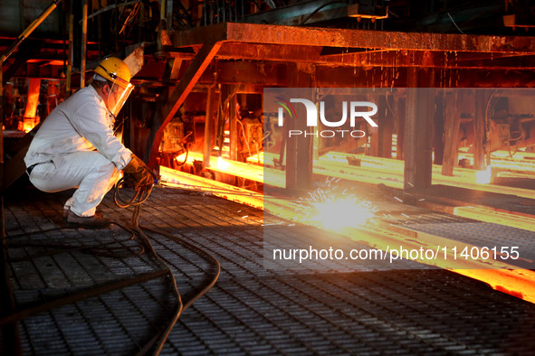 A worker is working at a steel casting workshop of a steel company in Lianyungang, China, on July 13, 2024. 