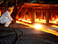 A worker is working at a steel casting workshop of a steel company in Lianyungang, China, on July 13, 2024. (