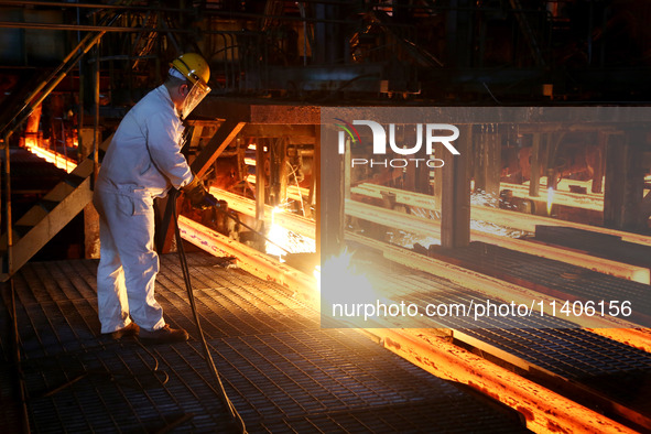 A worker is working at a steel casting workshop of a steel company in Lianyungang, China, on July 13, 2024. 