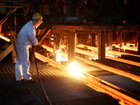 A worker is working at a steel casting workshop of a steel company in Lianyungang, China, on July 13, 2024. (